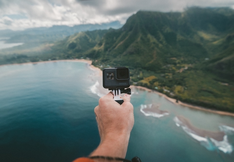 Man holding a go pro in Maui
