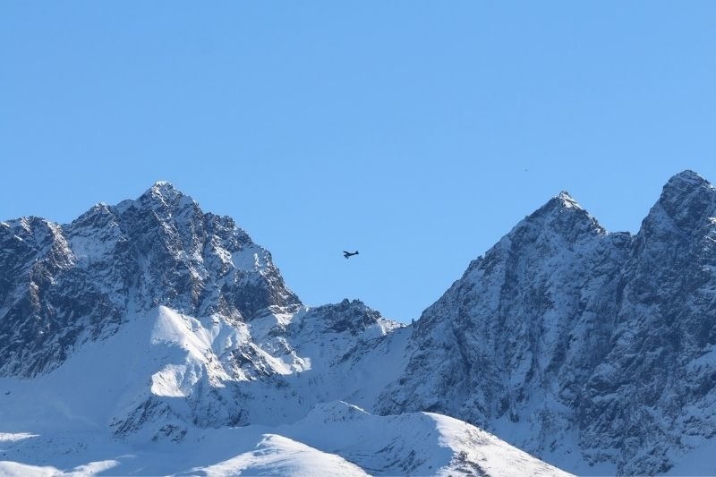 plane flying over snowy mountains in Alaska