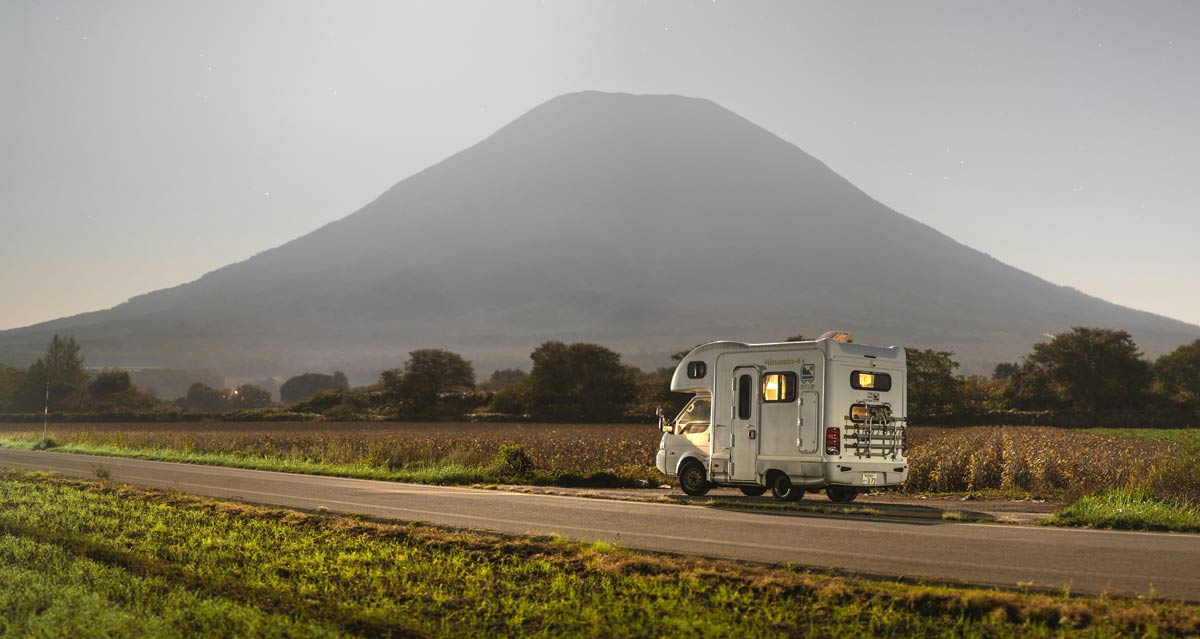 How to Rent a Campervan for the First Time: A Beginner's Guide 1 camper van driving with a mountain in the background